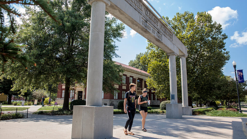 Visit Missouri Valley University A student walking beneath a campus colonnade on a sunny day