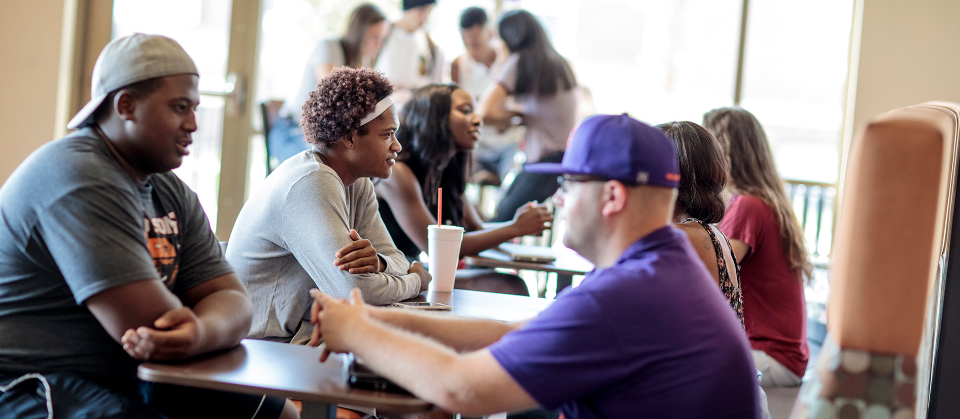 Housing & Residence Life Missouri Valley University students talking together at tables on campus
