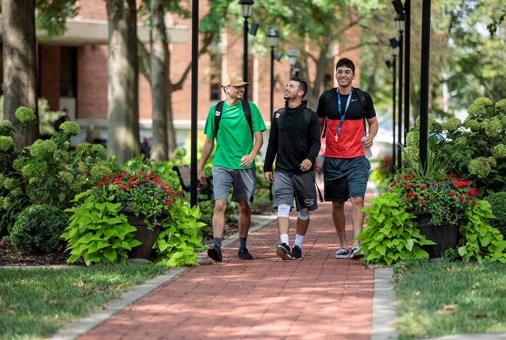 Tuition and Financial Aid Students walking together on a brick path across campus